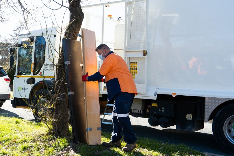 Man picking up bulky rubbish