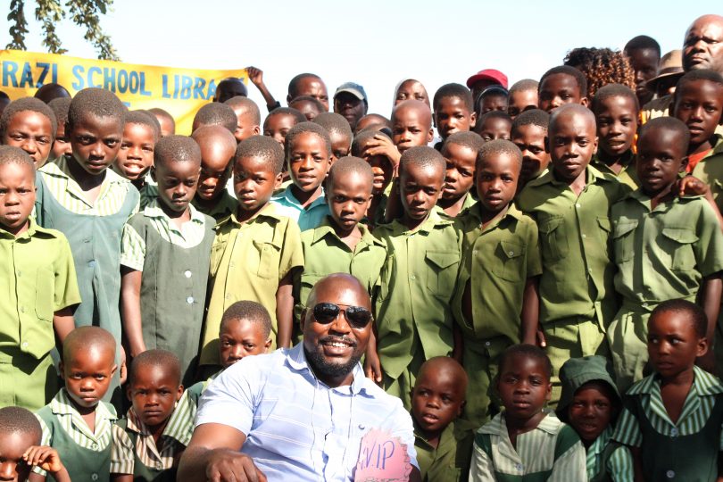 Alfred Chidembo surrounded by children in Zimbabwe