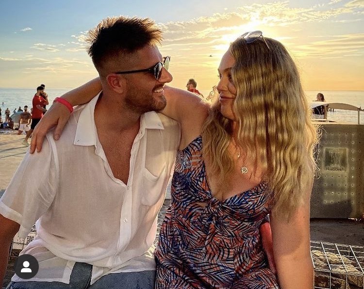 Bryce Ruthven and Melissa Rawson embracing at beach