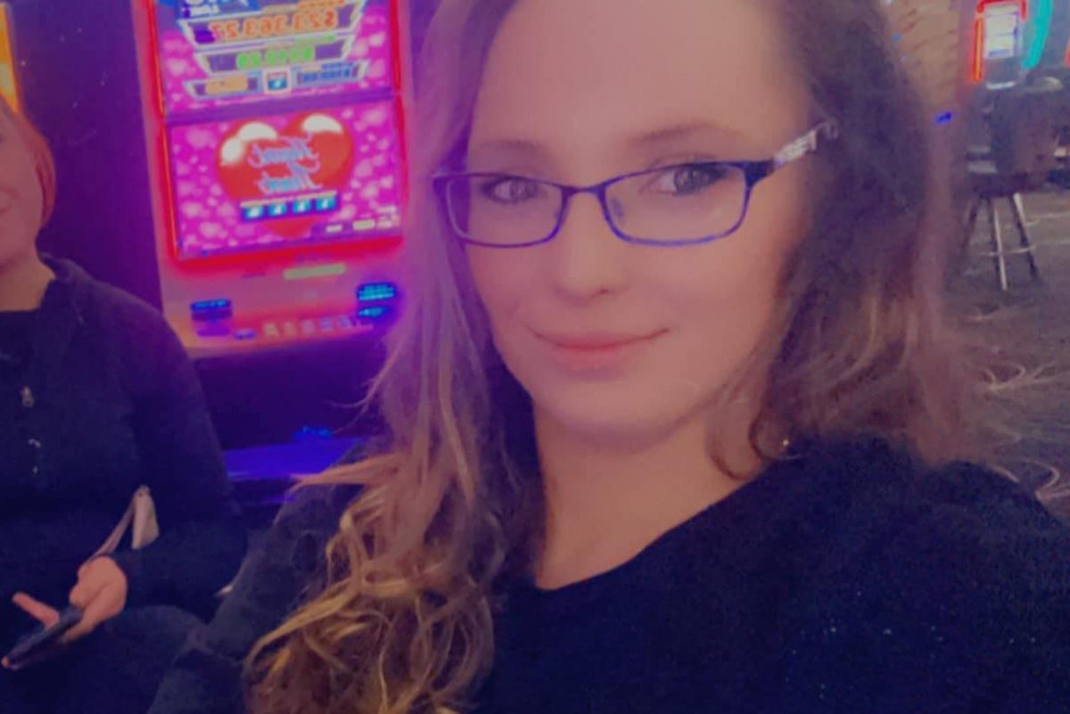 Woman sitting front of poker machines