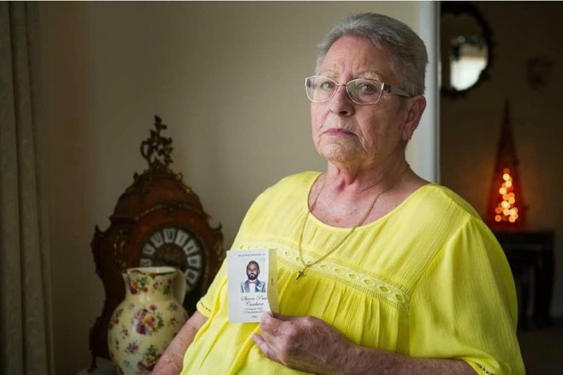 Yvonne Cuschieri holding an image of her son, Steven