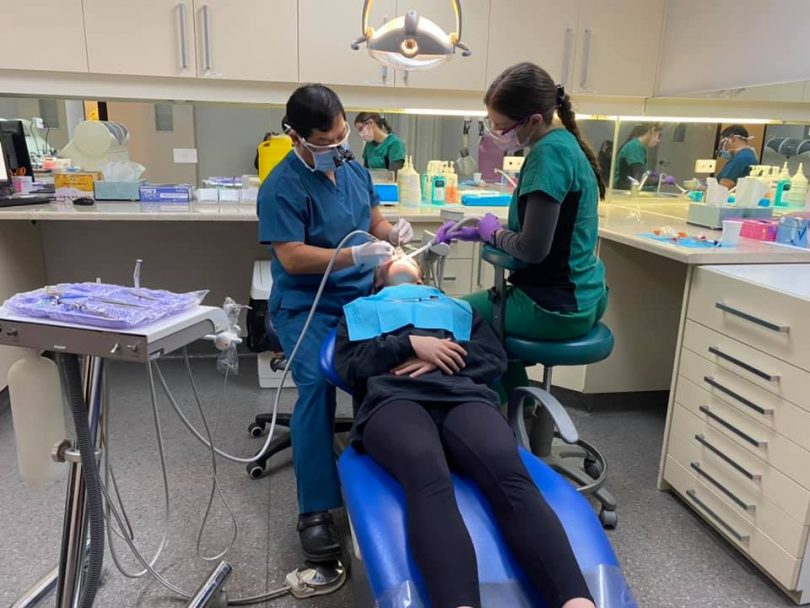 Dentist and assistant working on a patient