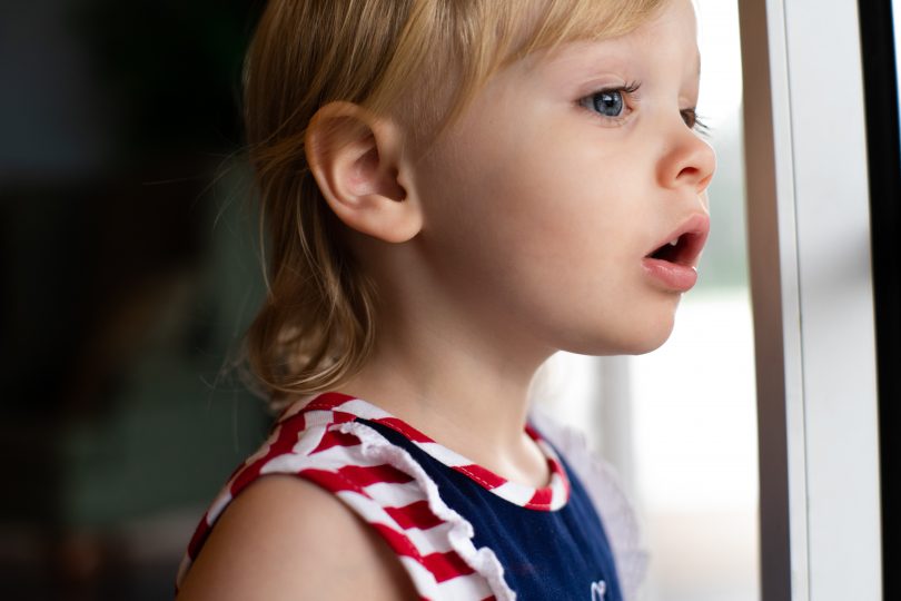 Child looking out a window