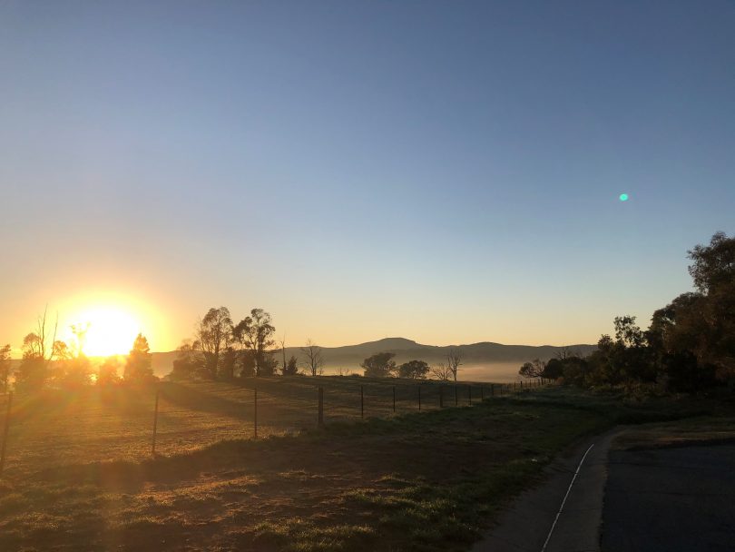 Sun rises over country property.