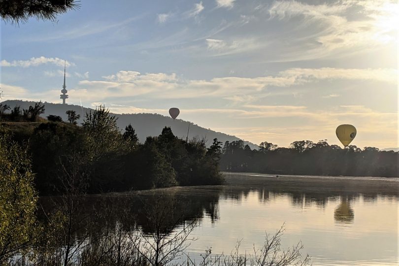 Hot air balloons float around Telstra Tower