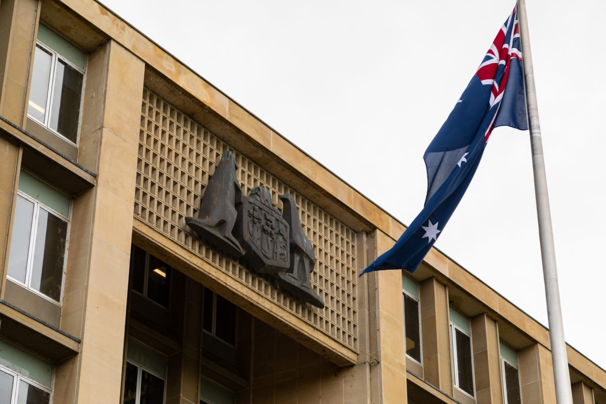 Government building with coat of arms and Australian flag