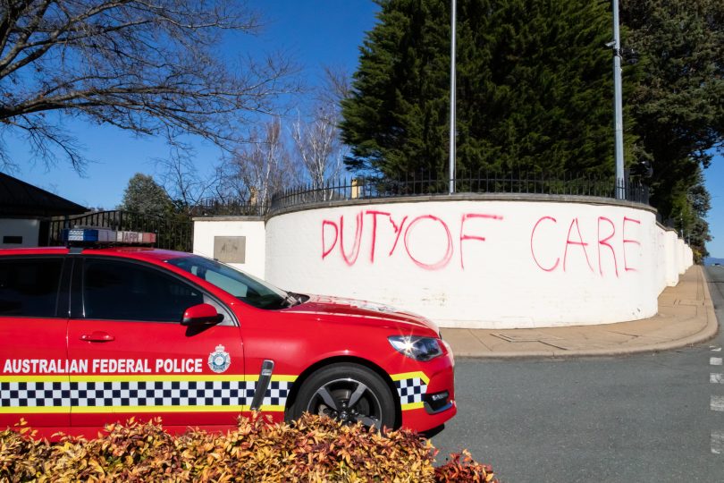 'Duty of Care' graffiti at entrance to The Lodge.