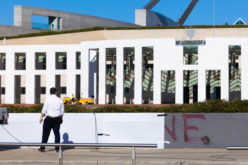 Staff covering up graffiti with paper at Australian Parliament House.