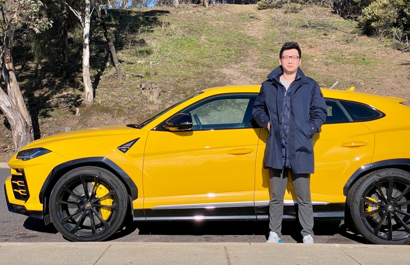 Jack Wang standing in front of yellow Lamborghini Urus