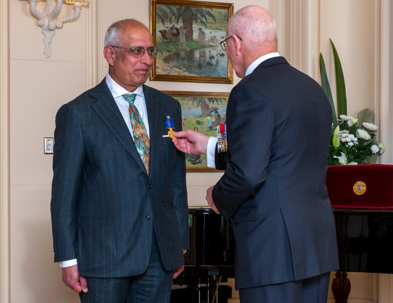 Lucky Prasad receiving an OAM from Governor-General David Hurley