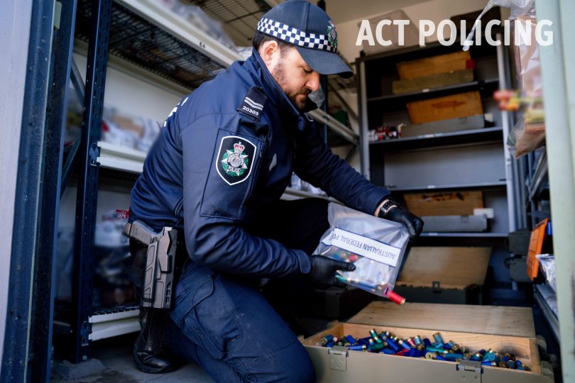 police officer with big box of ammunition 