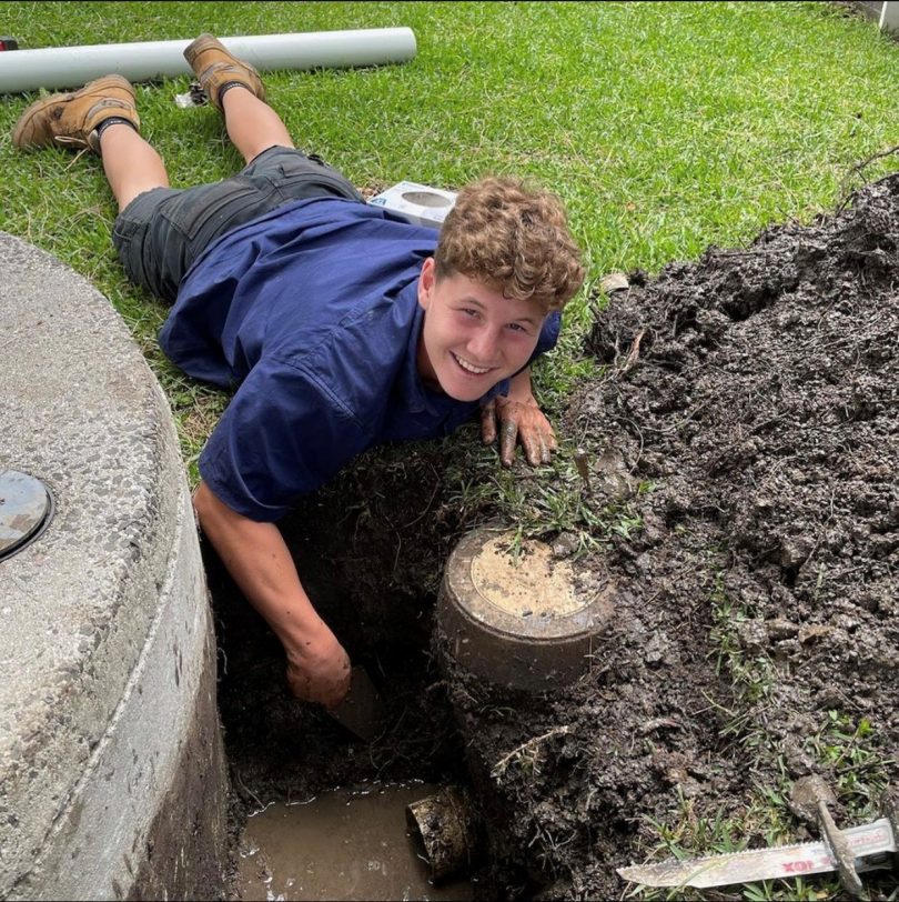 Bailey Sassall digging into muddy trench