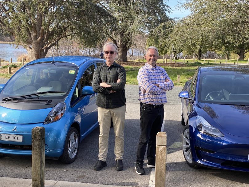 Owners standing next to electric vehicles