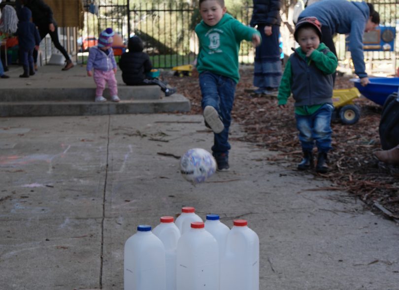 Child kicks ball into milk cartoons