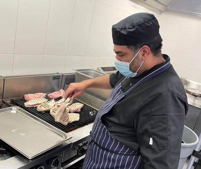 Garry Malhotra cooking in kitchen