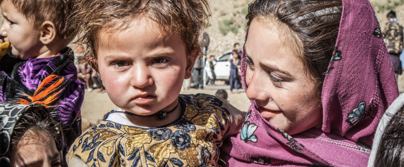 Afghan woman holding child