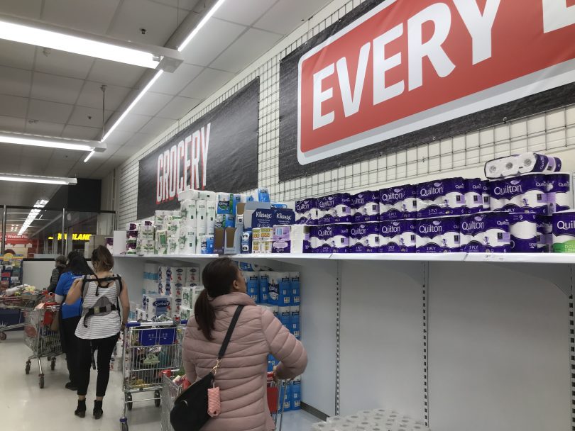 Empty toilet paper shelves in Coles supermarket