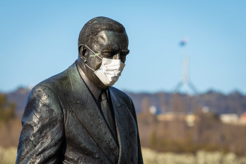 Sir Robert Menzies statue wearing a mask.