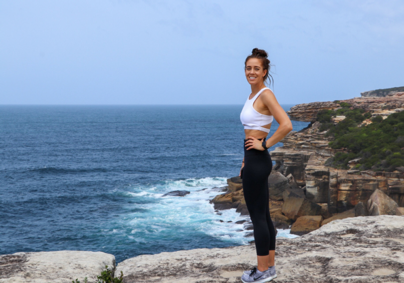 Sophie Ray standing on coastal cliff