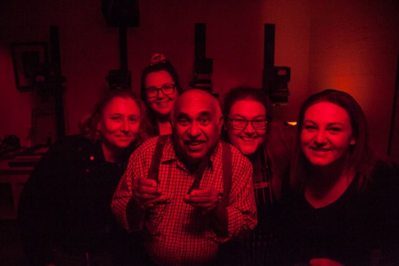 Merv Bishop and four women in photo darkroom