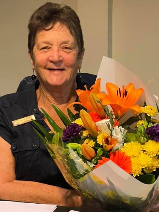 Helen Morgan holding flowers