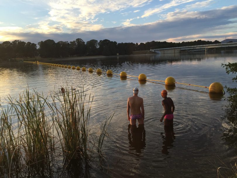 Ben Freeman and Eskindir Gavel swim training in Lake Burley Griffin