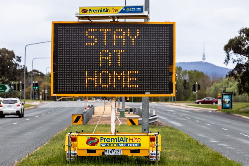 "Stay at home" COVID road sign