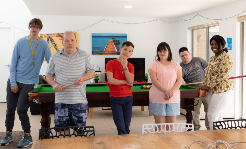 Group of people near a pool table