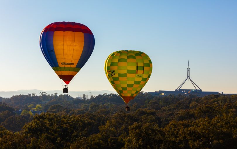 Two hot air balloons near Parliament House