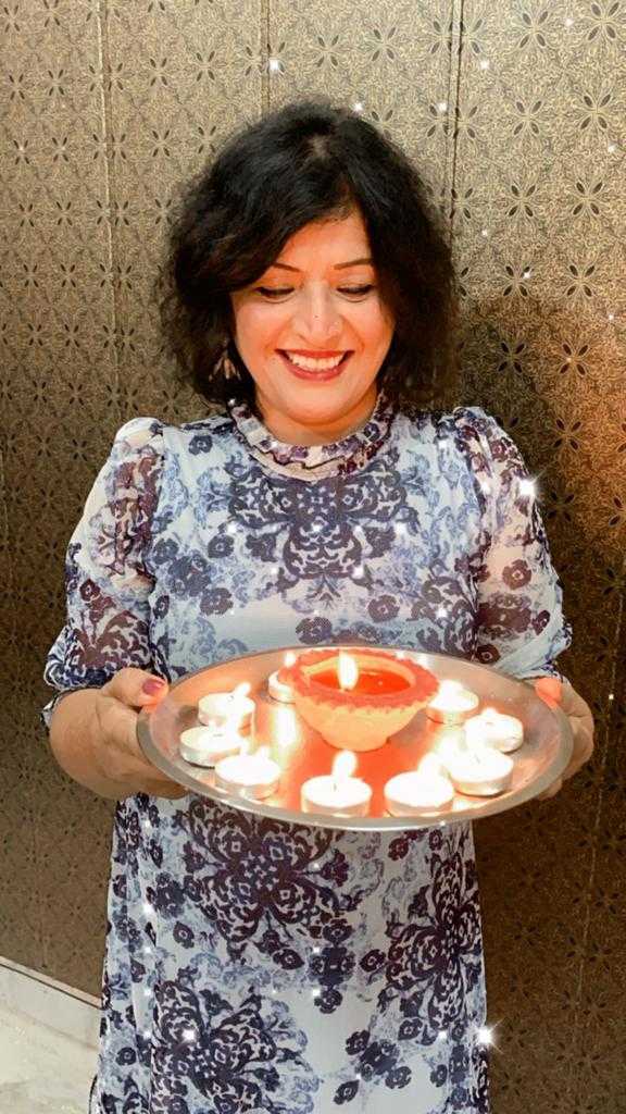 Indian woman holding candles