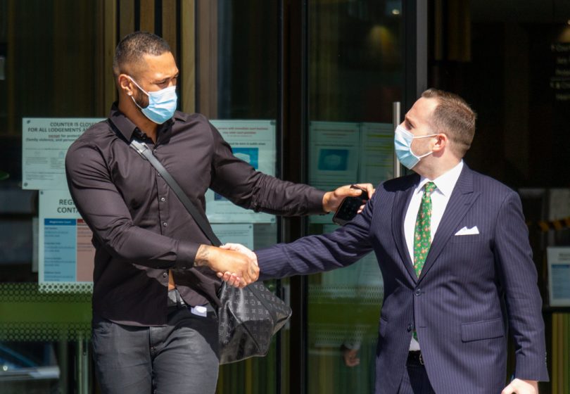 Two men outside the courts