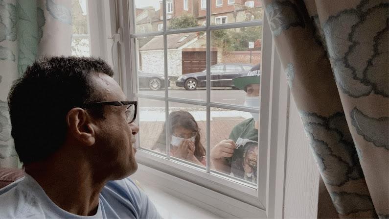 Man looking through window in scene from 'ShoPaapaa'