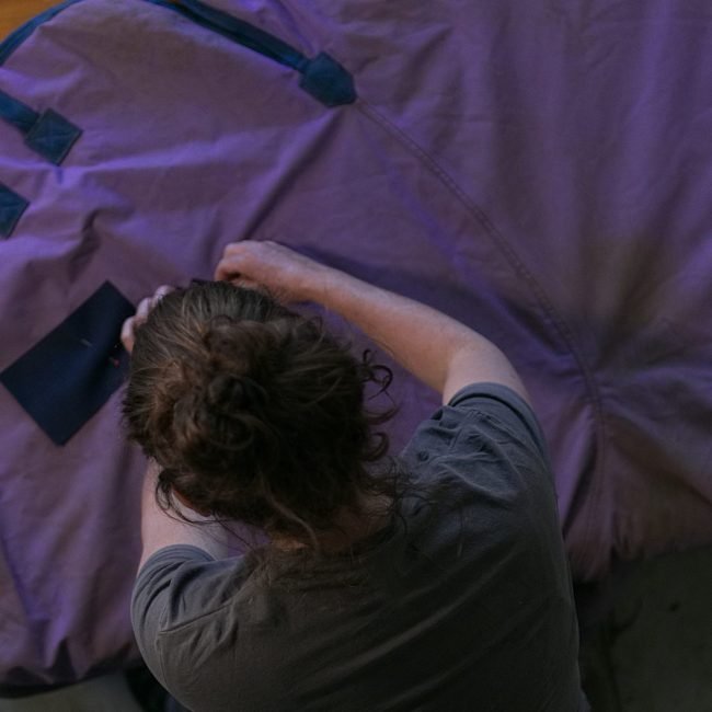 Woman working on horse rug