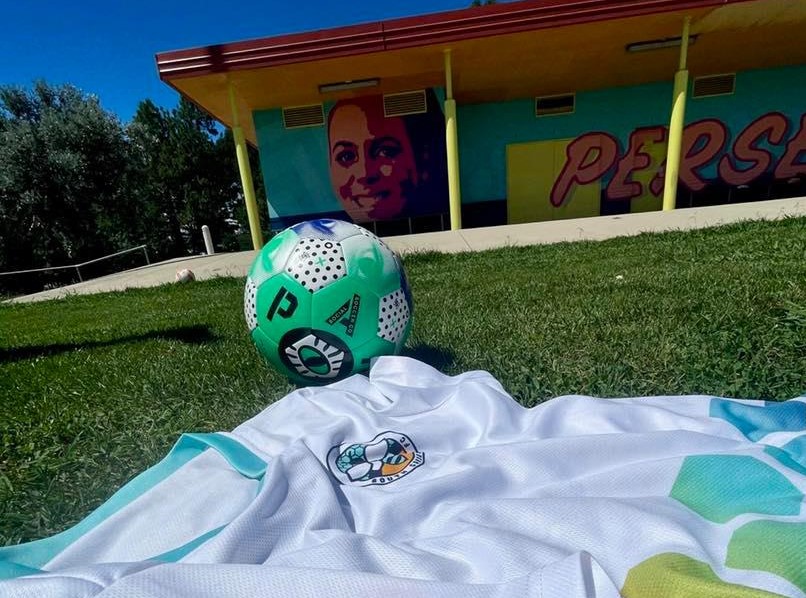 South Canberra Football Club jersey and ball on grass