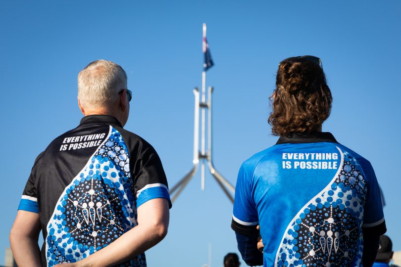 Two men looking at Australian Flag