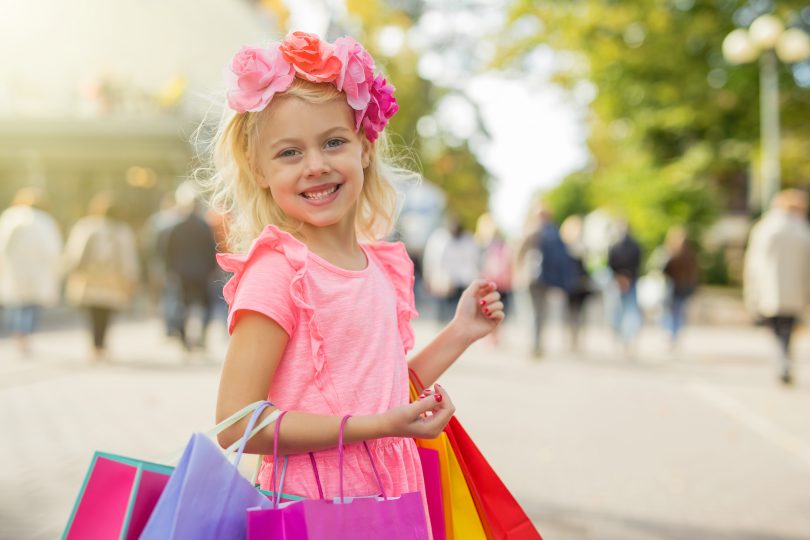 little fashionista holding shopping bags