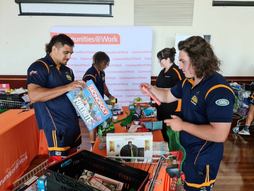 ACT Brumbies players lent a hand during last year’s Christmas Appeal, sorting and wrapping donations.