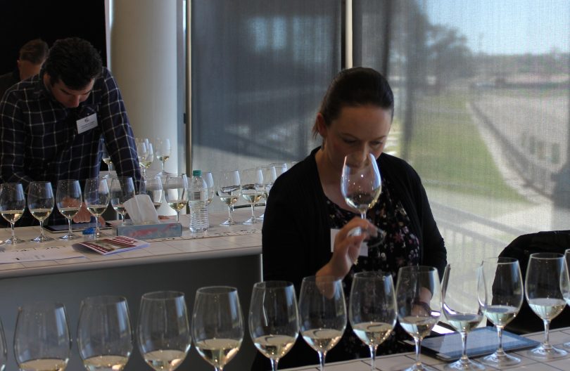 Woman tasting wine in competition