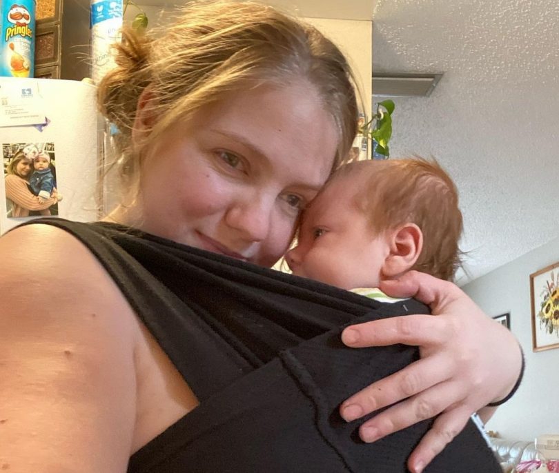 Samantha, a mum with vision impairment, holding her baby