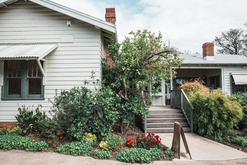 Exterior of weatherboard house with garden