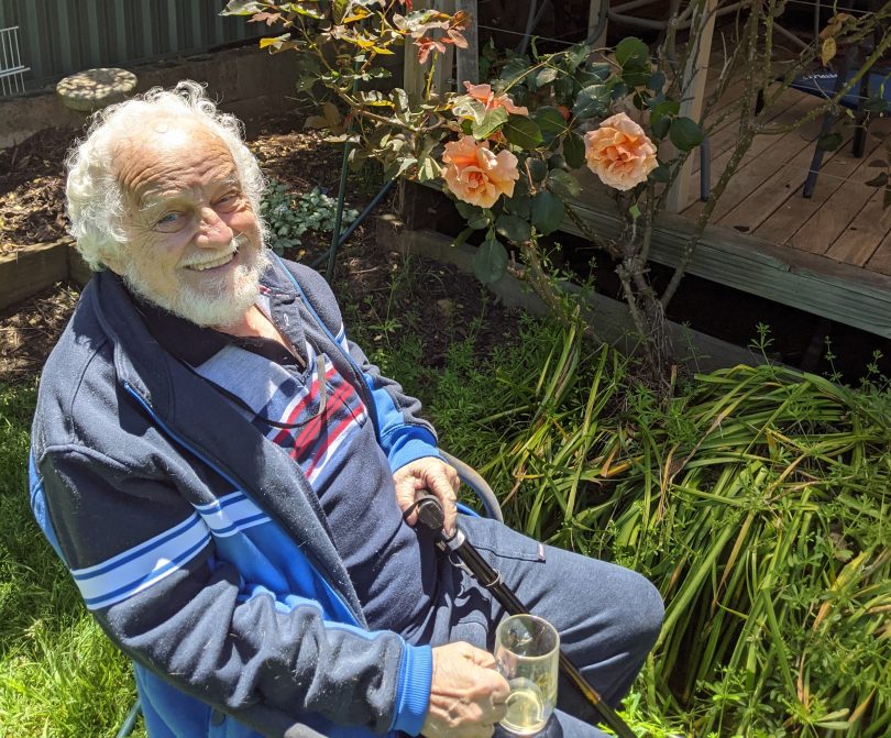 Syd Jones sitting in backyard