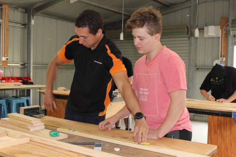 Teacher and student in construction class at Galilee School