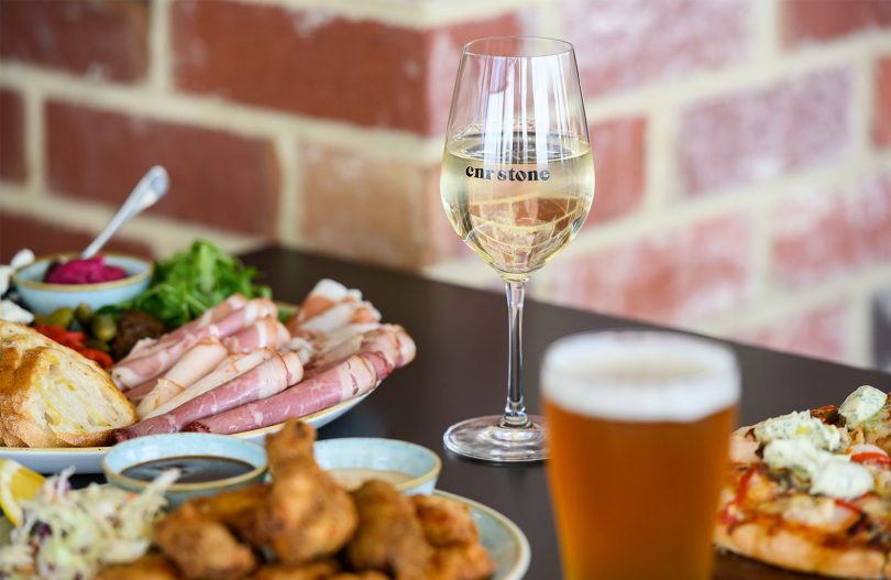 Cornerstone Pub wine glass and food items