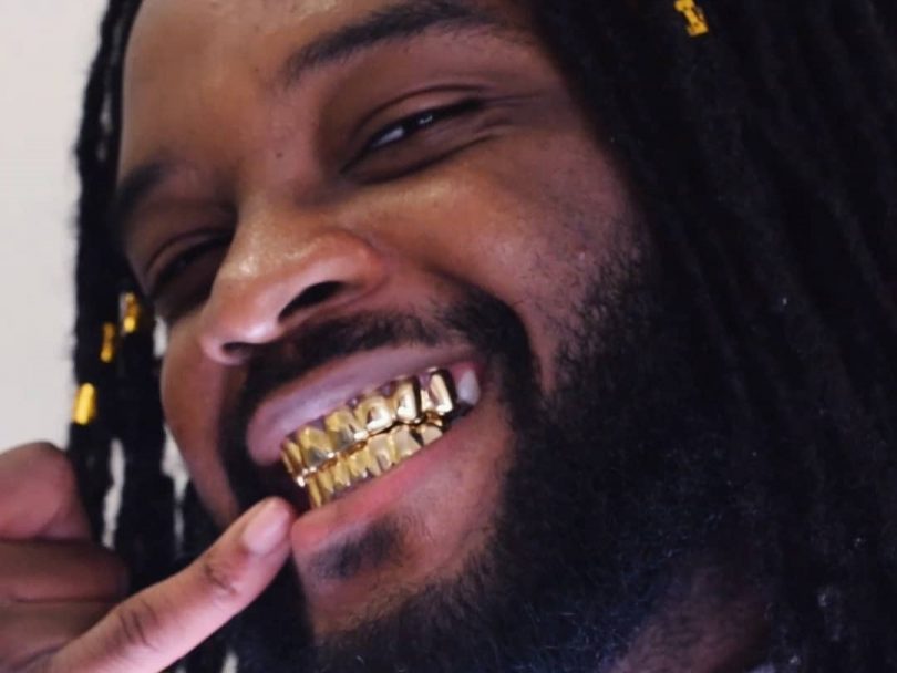 Genesis Owusu showing off his gold grill