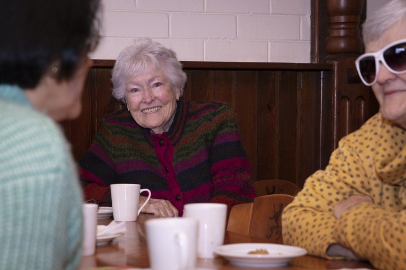 Smiling woman at a table