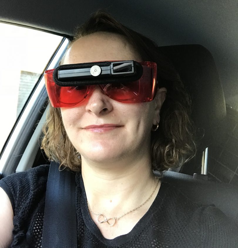 Belinda O'Connor in car wearing bioptic driving glasses