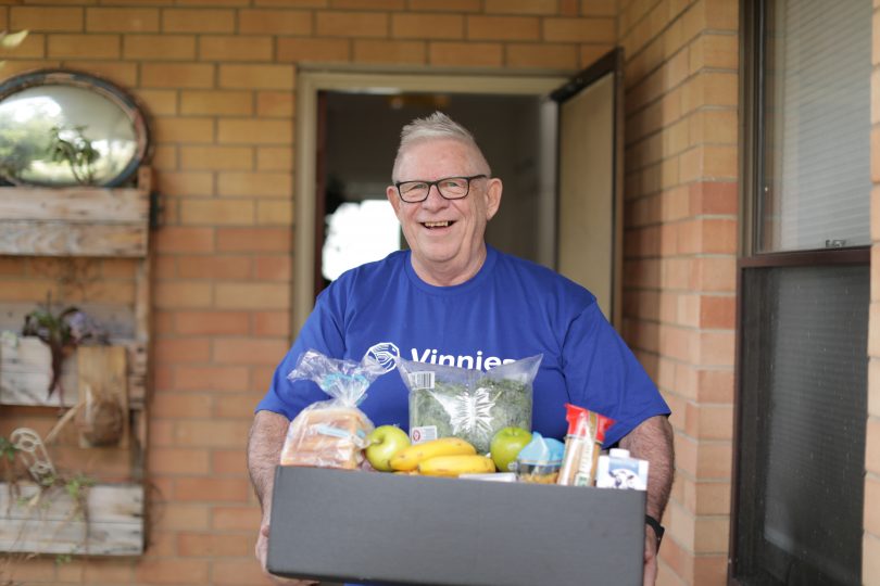 Vinnies volunteer with food hamper