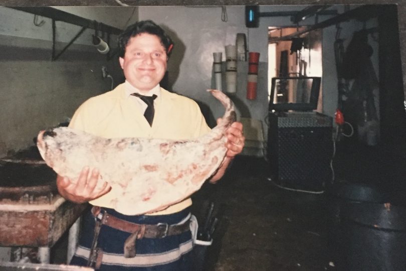 Bruce Booby in butchery holding meat