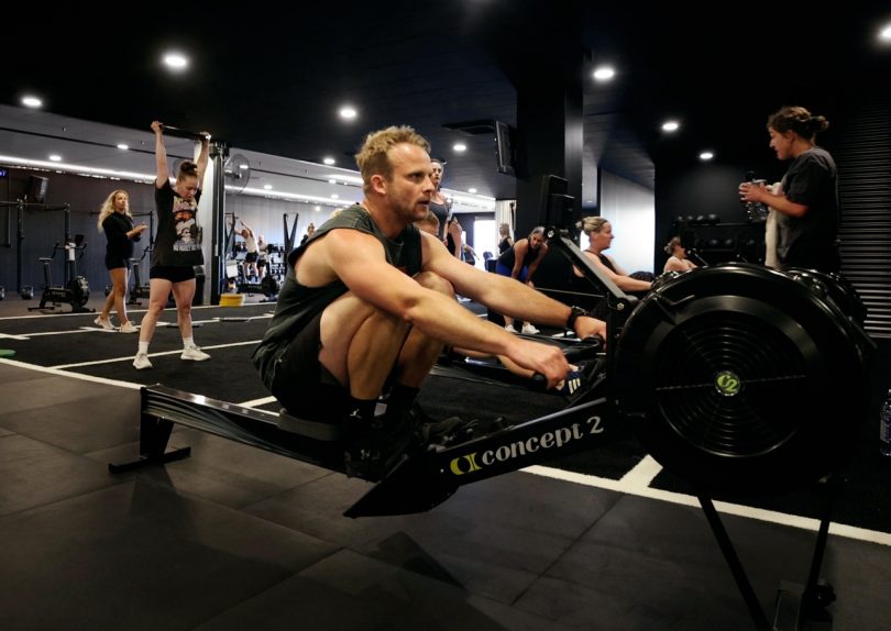 Man on rowing machine in gym