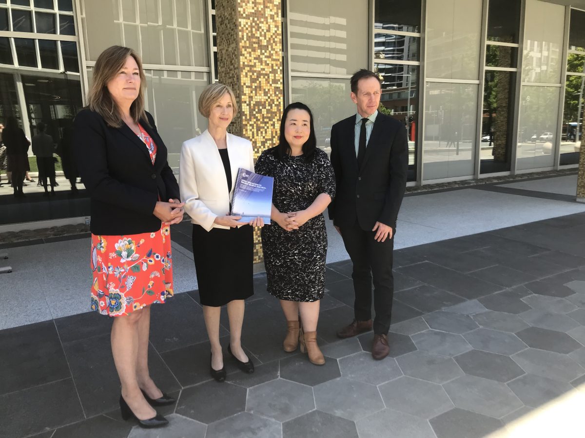 Acting Chief Minister Yvette Berry (left) accepts the report from committee chair Renee Leon alongside Canberra Liberals Leader Elizabeth Lee and ACT Greens Leader and Attorney-General Shane Rattenbury.